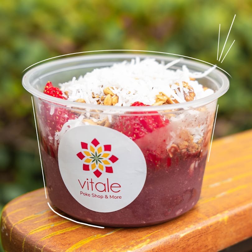 A Vitale Poke Shop & More acai bowl with strawberries, granola, and coconut flakes.